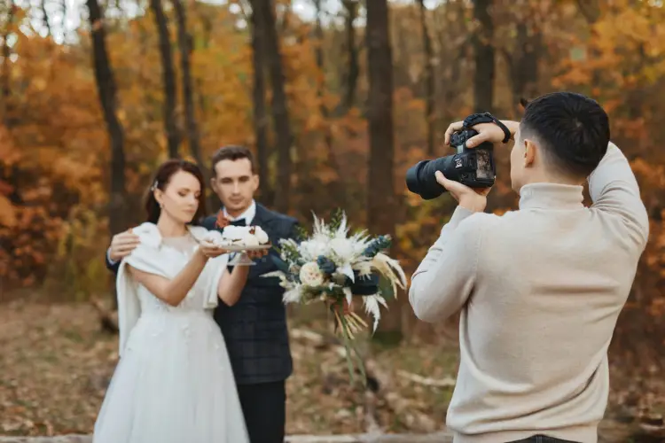 professional-wedding-photographer-taking-pictures-bride-groom-nature-autumn.jpg