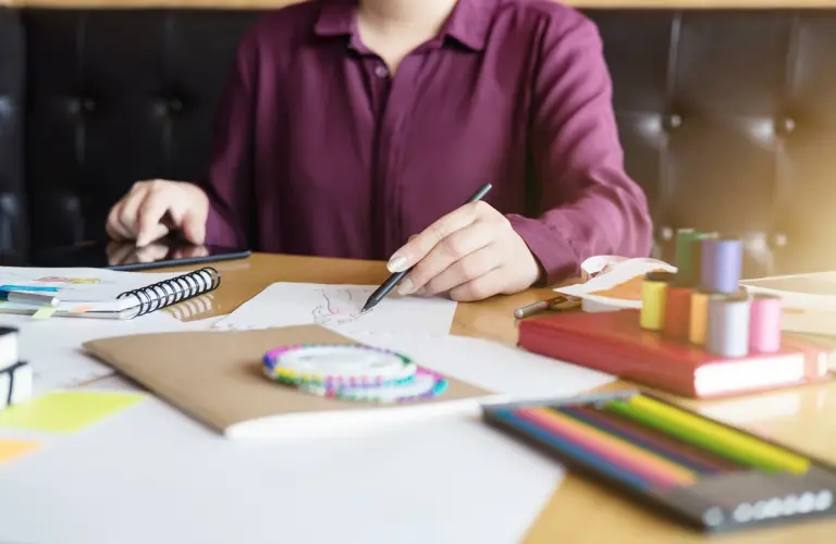 midsection-fashion-designer-sketching-paper-office.jpg