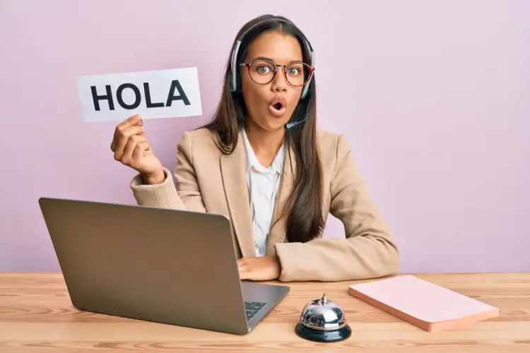 bilingual-woman-holding-hola-sign-headset.jpg